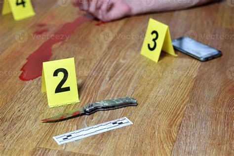 Crime Scene Investigation Bloody Knife And Victims Hand With Yellow Criminal Markers On