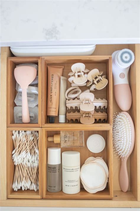 An Organized Wooden Drawer With Various Items In It Including Toothbrushes And Other Personal