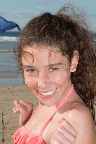 Happy Girl Smiling Portrait In The Beach Wearing An Orange Bikini