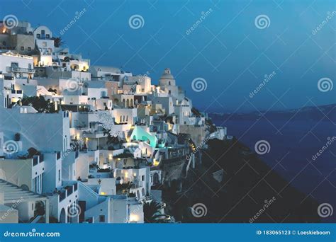 City Of Fira In Dusk Along Blue Ocean Santorini Greece Stock Image
