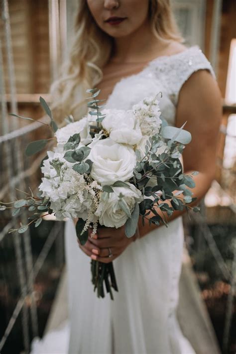 Sunflower bouquet with feathers and eucalyptus for rustic fall wedding. This Rustic Chic Wedding Redefines Modern Romance | Rustic ...