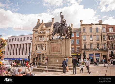 A Scenic View Of The Busy Durham City Centre Featuring The Statue Of