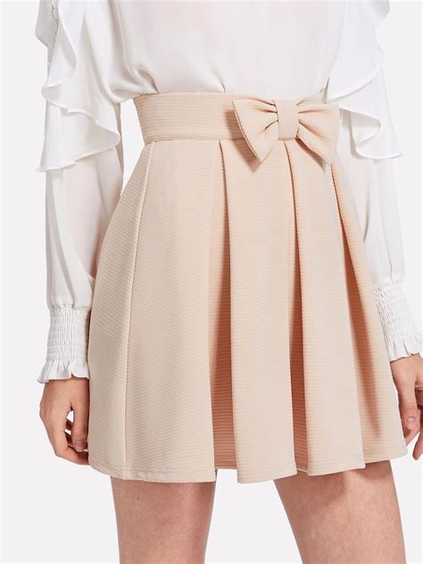 preppy plain flared mid waist beige above knee short length bow front box pleated textured skirt