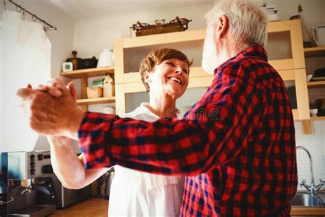 Senior Couple Dancing Together In Kitchen Stock Photo Image Of Female