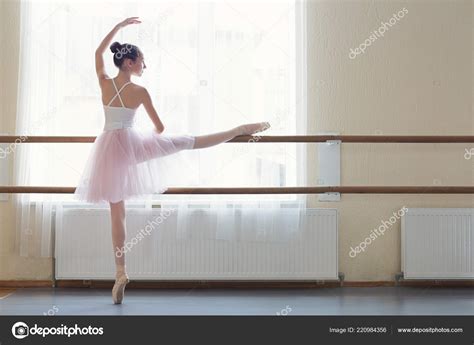 Young Ballerina Doing Exercise At Ballet Barre In Studio — Stock Photo