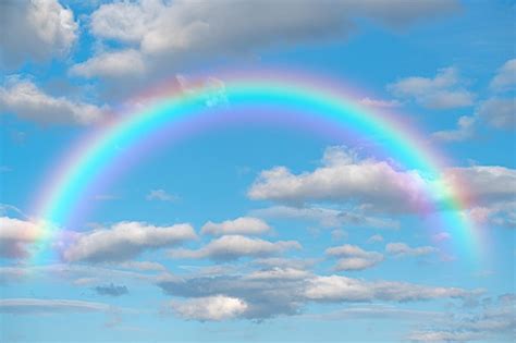 Premium Photo Rainbow Stunning Blue Sky Rainbow Big Fluffy Clouds