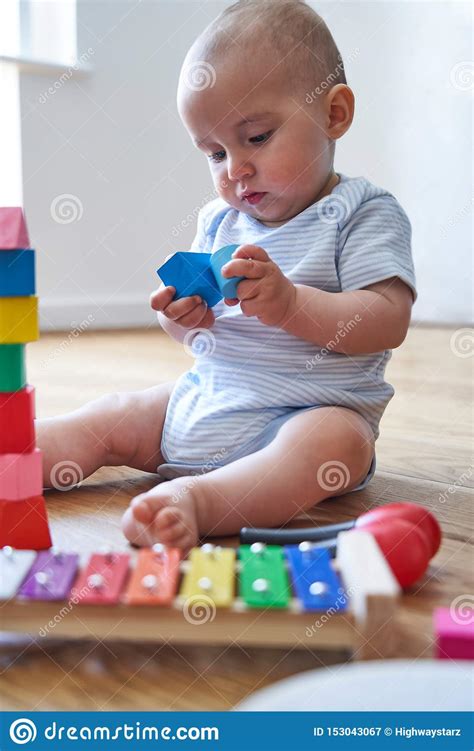 8 Month Old Baby Boy Learning Through Playing With Coloured Wooden