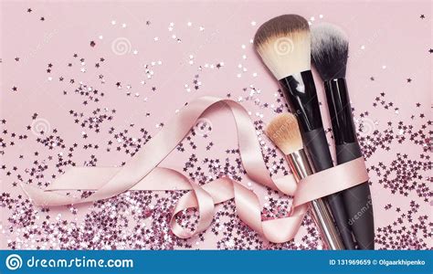 Different Cosmetic Makeup Brushes With Pink Ribbon And Holographic