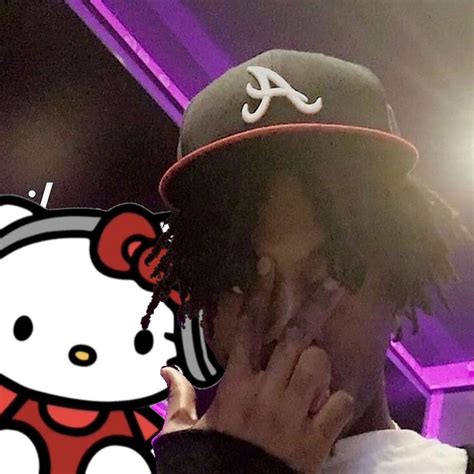 A Man With Dreadlocks And A Hello Kitty Hat