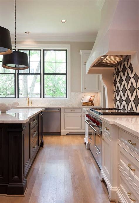 Here the black kitchen cabinets are with clear lines that combines classic and modern in one, and in addition, the intriguing brass geometry of the lamps and the contrasting white marble of the countertops create quite a dynamics. White Kitchen with Black Island and White Marble ...