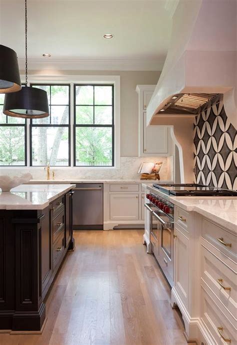 Also, black and white kitchens are bold and flexible. White Kitchen with Black Island and White Marble ...