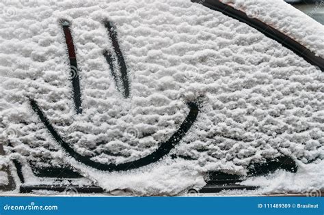 Snow Background Texture Of Wet Snow With A Cheerful Smiley Symbol