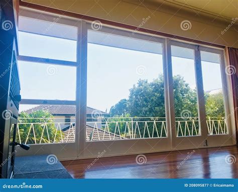 Floor To Ceiling Glass Windows And Doors With Balconies Outside
