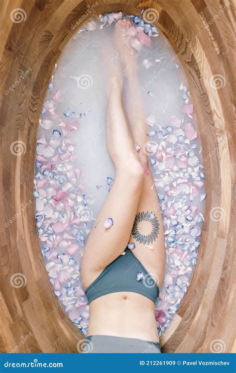 An Attractive Naked Girl Enjoys A Bath With Milk And Rose Petals Spa Treatments For Skin