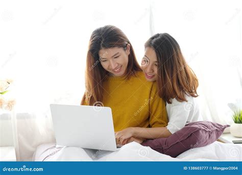 Young Cute Asia Lesbian Couple Using Laptop With Happiness At Home