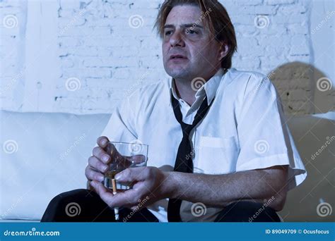 Depressed Alcoholic Businessman With Loose Necktie Wasted And Drunk