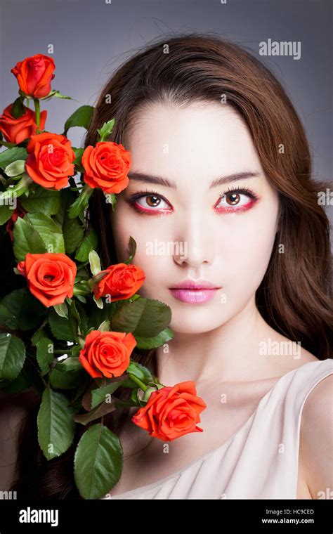 Portrait Of Young Korean Woman Posing With Red Roses Stock Photo Alamy