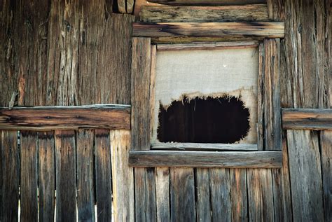 Two Images Of A Window In An Old Rustic Log Cabin