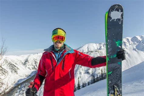 Portrait Young Man Ski Goggles Holding Ski In The Mountains Stock Image