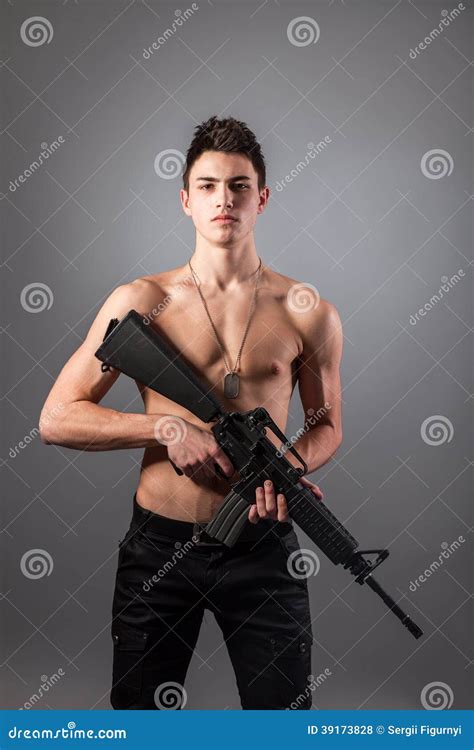 Handsome Bare Chested Soldier Is Holding A Rifle Stock Photo Image Of