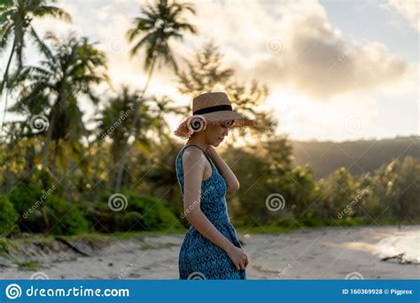 Woman Relaxing On The Beach With Sunrise In Koh Kood Island Stock Photo