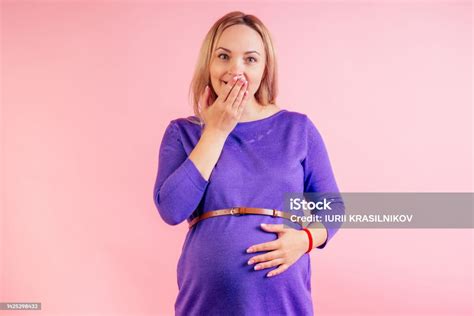 Beautiful Blonde Pregnant Sleepy Woman In A Violet Dress With Big Baby