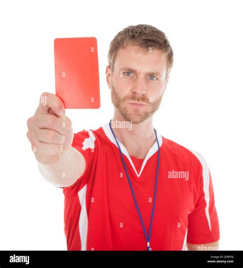 Full Length Portrait Of Referee Showing Red Card Over White Background