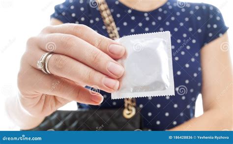 closeup image of pack of condom in female hand concept of contraception and safety in sex stock