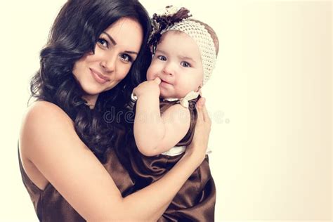Portrait Of A Beautiful Mother With A Small Daughter Stock Photo