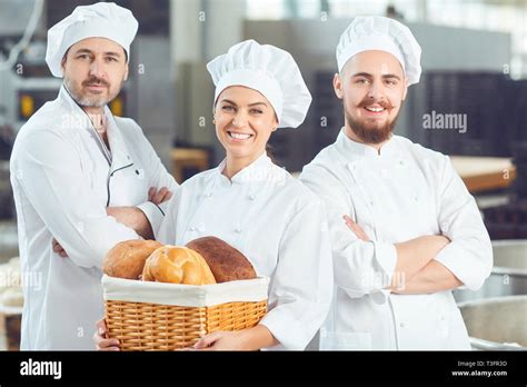 A group of bakers smiles at the bakery Stock Photo - Alamy