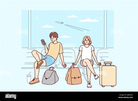 Happy Couple With Suitcases Sitting In Airport Ready For Summer Vacation Smiling Man And Woman