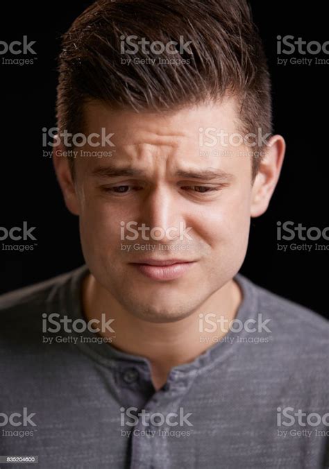 Worried Young White Man Looking Down Vertical Portrait Stock Photo