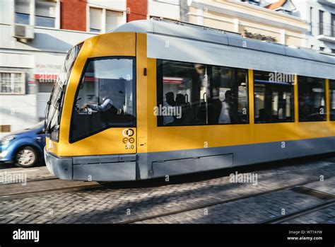 Yellow Inner City Tram With Passengers Stock Photo Alamy