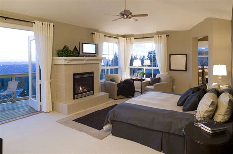 A Beautiful Contemporary Master Bedroom With Fireplace Balcony And