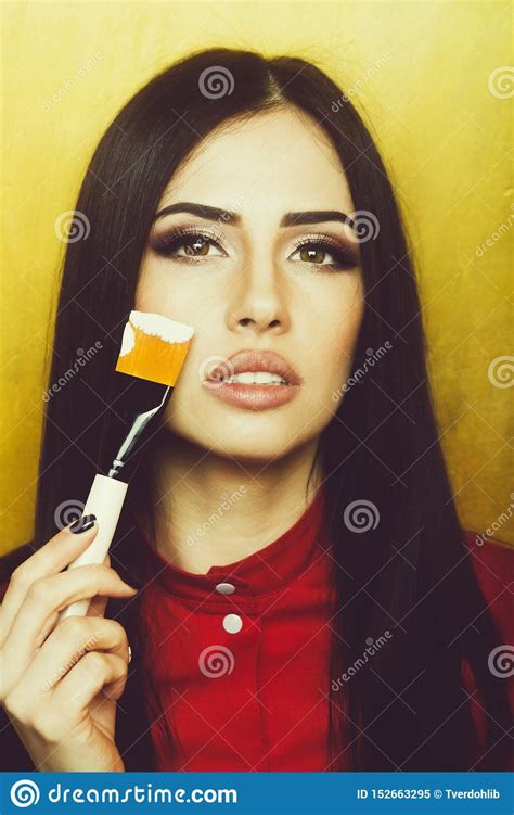 Pretty Brunette Woman Face With Artist Or Makeup Brush
