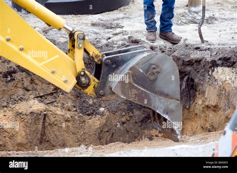 Back Hoe Shovels Dirt From Construction Site Stock Photo Alamy