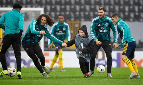 Watch the heartwarming moment Arsenal star Guendouzi holds mascots hand as child takes part in 