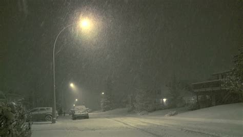 Car Traffic At Night On A Street Covered By Snow In Winter