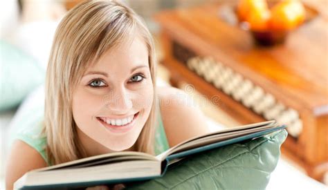 Happy Woman Lying On A Sofa Reading A Book Stock Image Image Of Glowing Laying 14141857