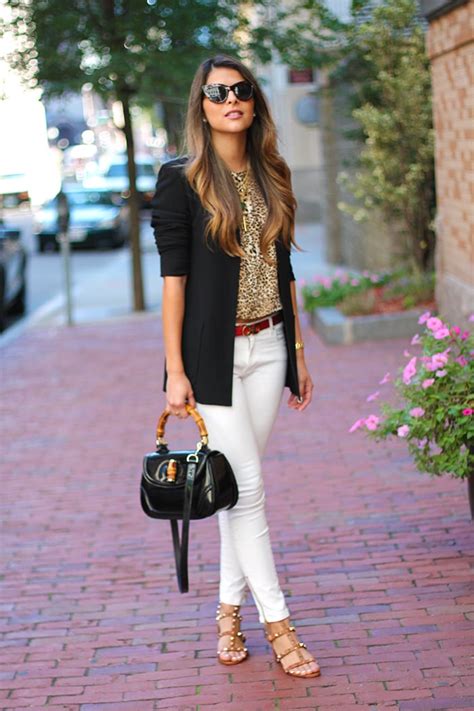 Black leather jacket over black top with blue jeans. White Jeans & Animal Print Top