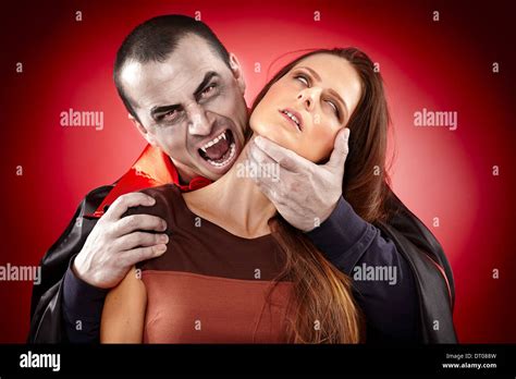 Vampire Preparing To Bite A Beautiful Womans Neck Stock Photo Alamy