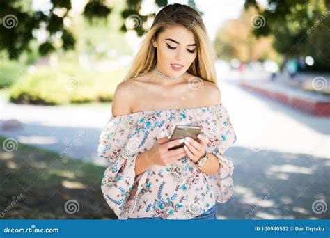 Woman Outdoors Texting On Her Mobile Phone In The Park Stock Photo Image Of Latinamerican