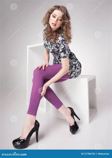 Beautiful Woman With Long Legs Dressed Elegant Posing In The Studio