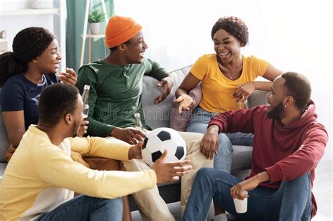 Group Of Cheerful Black Friends Getting Together To Watch Game Stock