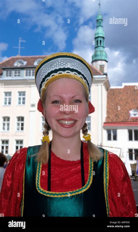 Prettysmiling Estonian Girl In Traditional Costume Welcomes Visitors