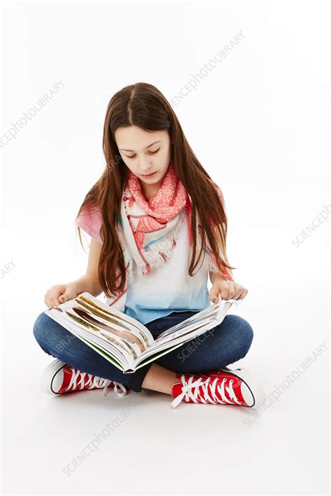 Girl Sitting Reading A Book Stock Image C0541951 Science Photo