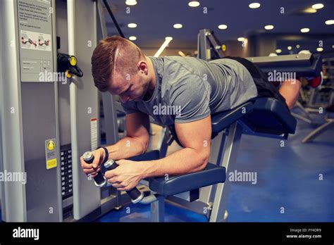 Man Flexing Leg Muscles On Gym Machine Stock Photo Alamy