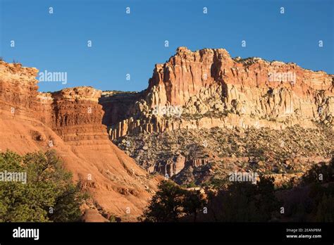 Sandstone Cliffs Of The Waterpocket Fold Towering Above Scenic Drive