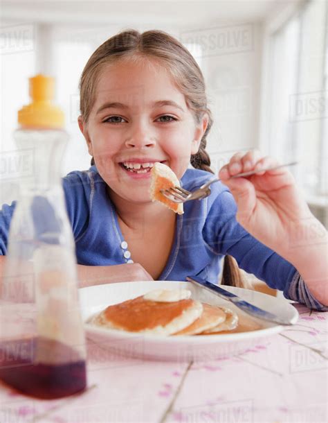 Young Girl Eating Pancakes Stock Photo Dissolve