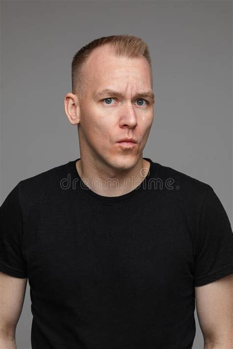 Portrait Of Caucasian Man In Black T Shirt Looks To The Left Isolated